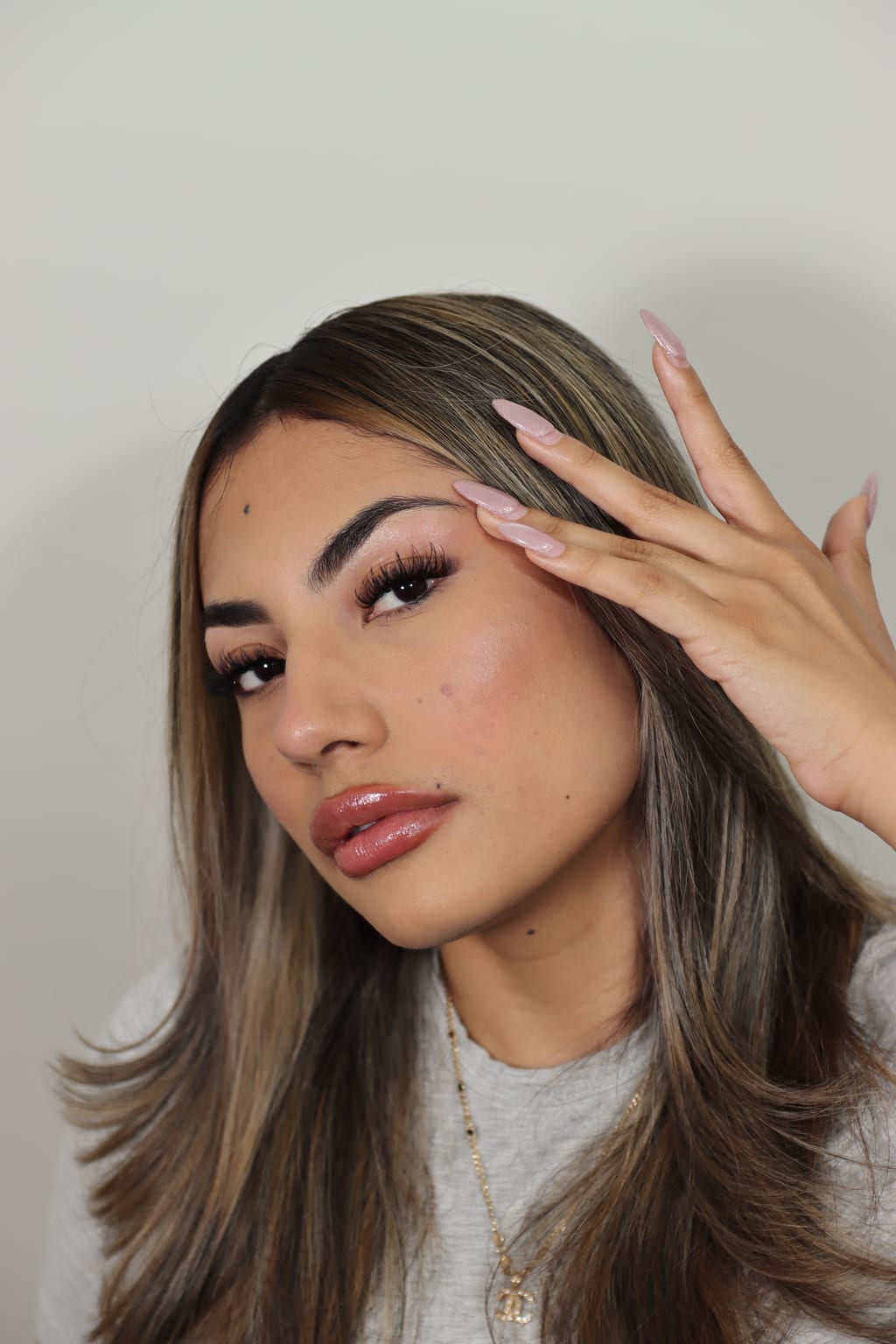 Portrait highlighting defined brows and lashes.