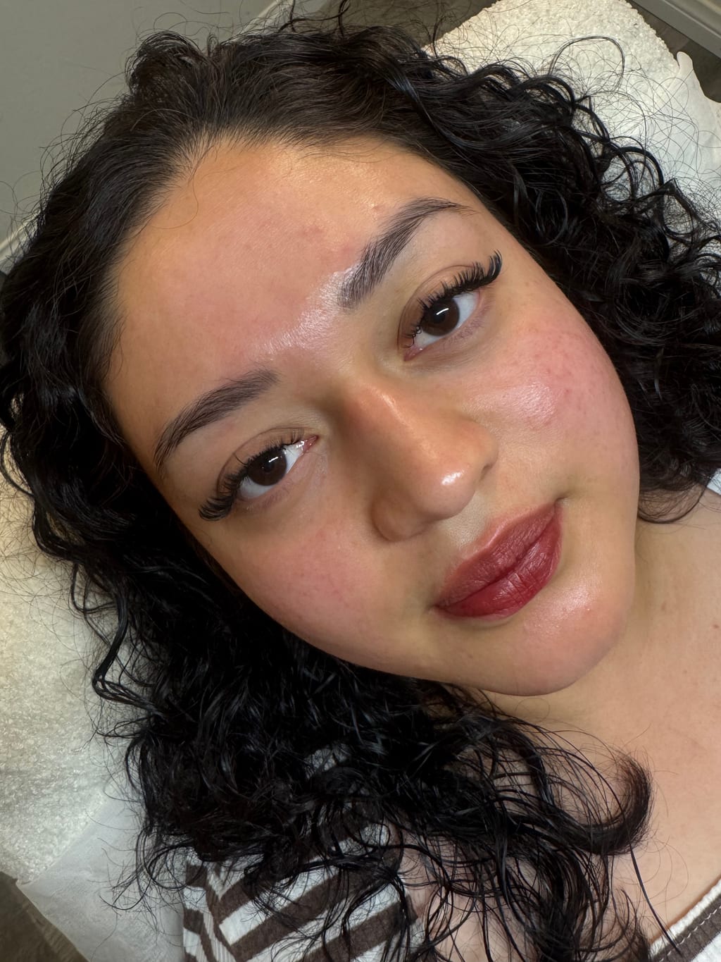 Client showing a finished lash extension set created by Coco at Silk Lash Empire.