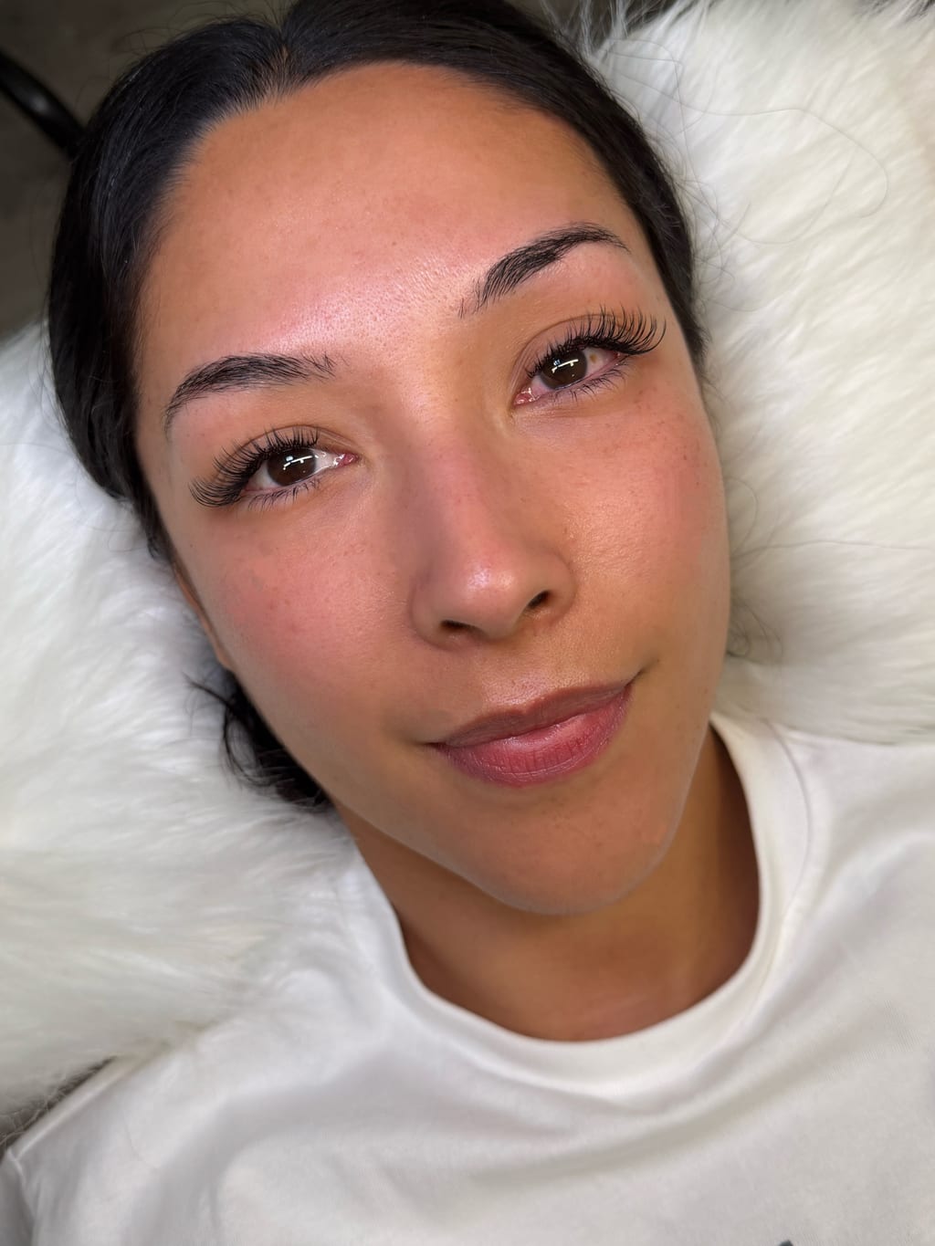 Reclining portrait showing softly defined lashes.